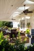 To provide the clients with protection from the sun and seasonal elements, we implemented a lean-to roof system for shade and shelter. The ceiling fans allow for a much-welcomed steady breeze during the warmer months, and the fixed skylights to allow for the natural sunlight to flood back into the house during the day. Photo of The Plank Residence modern home