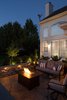 The neutral browns and tans of the patio play perfectly against the wrap-around drystack stone seating walls that double as extra seating for guests, as well as a clean “room” delineation. The area designated for the lounge furniture and fire table is perfect to curl up to that special someone on those chilly nights, but is versatile enough to become extra entertainment space when hosting a larger get-together! Photo 2 of The Plank Residence modern home