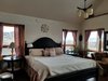 Modern home with Bedroom, Bed, Dresser, Wardrobe, Night Stands, Bench, Chair, Wall Lighting, Accent Lighting, Dark Hardwood Floor, Table Lighting, and Pendant Lighting. Master Suite Photo 3 of Modern Romantic Western Home For Sale