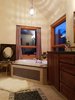 Modern home with Bath Room, Engineered Quartz Counter, Travertine Floor, Terrazzo Floor, Whirlpool Tub, Limestone Floor, Soaking Tub, Alcove Tub, Drop In Tub, Open Shower, Ceiling Lighting, Full Shower, Accent Lighting, Pendant Lighting, Table Lighting, Stone Tile Wall, Glass Tile Wall, Two Piece Toilet, Drop In Sink, and Mosaic Tile Wall. Master Bath with Chromeatherapy Jacuzzi Photo 6 of Modern Romantic Western Home For Sale