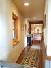 Modern home with Hallway and Dark Hardwood Floor. Sweeping hallways on each wing. Photo 11 of Modern Romantic Western Home For Sale
