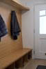 Custom entry bench designed by the architect, from a preliminary idea by the homeowner, provides space for coats and shoes at the street-level entry. Photo of Golden Gate Park Residence modern home
