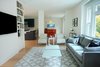 Two strong walls stand between the living room and dining room where a shear wall once existed and help to support a steel beam inside the ceiling above. Photo 7 of Golden Gate Park Residence modern home