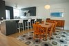 A long peninsula separates the spacious open kitchen from the dining area where a shear wall originally existed. A steel beam spanning the entire length of the home in the ceiling now supports that load . Photo 8 of Golden Gate Park Residence modern home