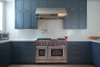 Significant kitchen storage frames the range and hood. All custom millwork. Photo 13 of Golden Gate Park Residence modern home