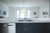 Two inch slab engineered quartz countertops are solid matte white. Photo 14 of Golden Gate Park Residence modern home