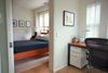 In the master suite, a large pocket door with glass insert separates the office and master bath from the bedroom. The natural steel frame desk with a solid cherry wood top is custom. Photo 15 of Golden Gate Park Residence modern home