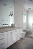 Master bath features matched honed marble surfaces on vanity top, floor, shower floor, and bench. Walls and shower ceiling are surfaced in large format porcelain tile. Wall hung vanity is custom. Photo 16 of Golden Gate Park Residence modern home