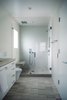The size of the master bath was increased during the renovation. The windowpane in the shower is sandblasted for privacy. The shower features traditional shower head; hand held shower; and rain shower above bench. Photo 17 of Golden Gate Park Residence modern home