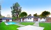 The beautifully landscaped backyard of this updated and expanded classic ranch home. Photo 5 of Quail Run modern home