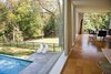 Looking our over the pool from the kitchen. Photo of Glass House modern home