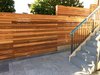 Modern home with Outdoor, Side Yard, Horizontal Fences, Wall, Walkways, Retaining Fences, Wall, and Stone Patio, Porch, Deck. Cedar privacy screen fence and stone paver patio & path Photo 6 of Port Moody Makeover
