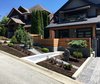 Modern home with Outdoor, Shrubs, Slope, Retaining Fences, Wall, Front Yard, Concrete Fences, Wall, Horizontal Fences, Wall, Wood Fences, Wall, and Trees. Front yard, view from the street of the planted area and retaining walls Photo 3 of Port Moody Makeover