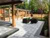 Modern home with Outdoor, Shrubs, Back Yard, Raised Planters, Stone Fences, Wall, Trees, Stone Patio, Porch, Deck, Horizontal Fences, Wall, Vegetables, Walkways, Hardscapes, Grass, and Wood Fences, Wall. Backyard oasis: patio, vegetable garden grow zone, pergola walkway to (lower level) sports court Photo of Port Moody Makeover