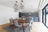 Modern home with Dining Room, Table, Chair, Storage, Ceiling Lighting, and Medium Hardwood Floor. Smart lighting and in-ceiling speakers in the living room Photo 2 of Regent's Park Townhouse