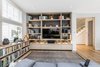 Modern home with Living Room, Sofa, Bookcase, Console Tables, Ceiling Lighting, and Medium Hardwood Floor. Media room snug downstairs Photo 5 of Regent's Park Townhouse
