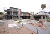 A spiral staircase leads from the backyard to the 3rd story deck. A mix of permeable pavers, gravel, and mulch create an eye-catching pattern and also serve as filtration for stormwater. The backyard also features a jacuzzi and firepit. Photo 5 of The Jaska Nolan Residence modern home