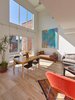 Double-height living space provides an abundance of natural light and enables cross ventilation. Photo 2 of 10th Street Duplexes modern home