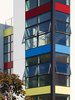 Brightly colored aluminum panels draw passersby in while corner-wrapping windows give residents a feeling of openness and sense of eyes on the community. Photo of Bailey Lofts modern home