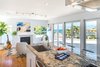 Kitchen Island work station overlooks the living room with fireplace, expansive balcony with ocean views, and the dining and bar areas that overlook the backyard (out of frame). Photo 2 of The Beach House modern home