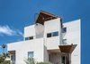 Three stories of ocean views, and a unique boat-bow balcony offers a bit of humor to this beachy neighborhood. Photo 4 of The Beach House modern home