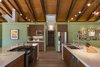 White marble counters and wood cabinets create the central focal point for this Mission-style home. Photo 6 of The Modern Mission modern home