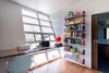 The second story home office features a dramatic angled wall with a motorized garage-door style window that can open up from the ground floor. Photo 2 of The Ranch House modern home