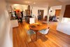 Under the original shag carpeting that came with the 1954 home, there was beautiful wood flooring. The kitchen, dining, and living spaces were opened up to create a more interactive home environment. Photo 3 of The Ranch House modern home