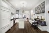 Modern home with Kitchen, Marble Counter, White Cabinet, Medium Hardwood Floor, Accent Lighting, Ceiling Lighting, Refrigerator, Wall Oven, Cooktops, Range, Dishwasher, Drop In Sink, and Microwave. KITCHEN:
-Custom Sonoma Subway Tile
-Perrin & Rowe faucet with instant hot water
-Vented Hood over chef's Wolf Dual Fuel stove
-SubZero Refrigerator with matching cabinetry front
-Wolf Combination Microwave/Convection Oven
-Custom banquette with additional storage
-Absolute Black polished 2 thick granite countertops
-Oversized island topped with 2 inch thick Carrera marble
-Custom cabinetry all with dovetail soft auto-close drawers
-Bosch Dishwasher
Full size Electrolux Washer and Dryer Photo 9 of Renovated Brownstone Living