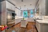 Modern home with Kitchen, White Cabinet, and Medium Hardwood Floor. Beautiful Chef's Kitchen - Perfect For Entertaining Photo 9 of Artistry & Modernity: Maisonette West