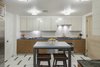 Modern home with Kitchen, Wall Oven, Dishwasher, Drop In Sink, Ceiling Lighting, White Cabinet, and Refrigerator. A formal and functional chefs kitchen with enough room for additional seating Photo 4 of NYC Duplex with Water Views in Peter Marino-Designed Condo