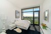 Modern home with Bedroom, Bed, Storage, Bookcase, Floor Lighting, Night Stands, and Lamps. Simplicity at its finest in this bedroom. Your eye is drawn outside. Photo 5 of NYC Duplex with Water Views in Peter Marino-Designed Condo