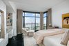 Modern home with Bedroom, Bookcase, Storage, Dresser, Bed, and Chair. This sumptuous master bedroom suite beckons for lazy mornings Photo 6 of NYC Duplex with Water Views in Peter Marino-Designed Condo