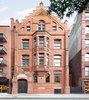 Modern home with Exterior, Apartment Building Type, Brick Siding Material, and Stone Siding Material. Steeped in history, the building was constructed in 1888-1889 for the Children's Aid Society, and designed by the firm of Vaux & Radford. It remains to this day one of the most striking examples of Victorian Gothic architecture in all of New York. Adorned with carved stone, terra cotta and pressed Philadelphia brick, the building was converted to co-op in 1972 and later designated a New York City Landmark in 1977. Photo 2 of Renovated Co-op in Historic Astor Memorial School
