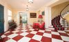 The foyer features a red & white checkerboard floor and a winding staircase to the second level Photo 2 of Regal in Westchester modern home