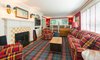 Modern home with Living Room, Chair, Wood Burning Fireplace, Media Cabinet, Bookcase, Sofa, and Lamps. With warm hues and rich overtones, the home exudes luxurious comfort Photo 4 of Regal in Westchester