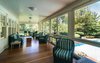 Modern home with Living Room. Take a breather on the covered porch overlooking the outdoor pool Photo 7 of Regal in Westchester