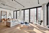 Modern home with Living Room, Light Hardwood Floor, Ceiling Lighting, and Sofa. The large living room is accentuated by massive floor to ceiling windows which draws in sunlight against the neutral palate. Photo of Curated East Village Penthouse