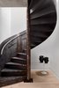 Modern home with Staircase, Metal Tread, and Metal Railing. Stunning spiral staircase leads to the private 1,000 SF roof deck perched above the Bowery. Photo 9 of Curated East Village Penthouse