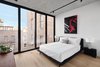Modern home with Bedroom, Ceiling Lighting, Light Hardwood Floor, and Bed. Another bedroom - and a pop of color courtesy of Good Luck Dry Cleaners. Photo 8 of Curated East Village Penthouse