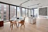 Modern home with Dining Room, Bench, Light Hardwood Floor, and Ceiling Lighting. The dining area, located off open kitchen, makes entertaining easy. Photo 3 of Curated East Village Penthouse