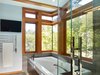 The modern bathroom gently connects to outdoors through butt-corner windows Photo 5 of The Gravity House modern home