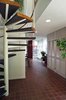 Looking beyond Hoover's circular staircase and closets to the new vestibule, with Heather Brown quarry tiles. Photo 5 of Giese House modern home