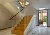 The stair of reclaimed heart pine risers and treads and a cherry railing, between irregularly spaced steel rods. Photo 5 of Sustainable Urban Villa modern home