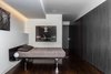 Modern home with Bedroom, Bed, Ceiling Lighting, Accent Lighting, and Dark Hardwood Floor. Master Suite + Hall - bed: Alias, Rift-cut white oak, full-height, honeycomb panels and doors: hand wire brushed, stained, sealed, sanded, glazed, sanded and top-coated Photo 2 of Castro Residence