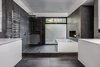 Modern home with Bath Room, Porcelain Tile Floor, Drop In Sink, Soaking Tub, Open Shower, Recessed Lighting, and Porcelain Tile Wall. Master Bathroom - soaking tub w/ linear fireplace - White thermafoil floating vanities, Duravit and Hansgrohe fixtures, Large-format Italian porcelain tile from Emil Ceramica Photo 3 of Castro Residence