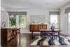 Modern home with Dining Room, Table, Ceiling Lighting, Pendant Lighting, Chair, and Dark Hardwood Floor. Open Dining / Kitchen / Living - European fumed chestnut cabinetry, featuring quarter-sawn, sequenced veneers and an oiled finish, Louis Poulsen pendant lights, Recreated original baseboards, window trim, and picture rail from original 1905 detailing, Vintage rosewood bar stools by Erik Buc, Vintage Danish dining table by Gunni Omann Photo 11 of Castro Residence