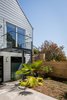 Modern home with Outdoor, Back Yard, Horizontal Fences, Wall, Small Patio, Porch, Deck, Shrubs, and Wood Fences, Wall. Backyard + Spiral Stairs + GlasBackyard + Spiral Stairs + Glass Deck - Large-format Italian porcelain tile from Emil Ceramica, Custom steel and glass deck. Glass decking and railings by Paige Glass, Plantings & planters by Flora Grubb Gardens, Louis Poulsen sconces Photo 10 of Castro Residence