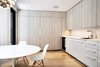 Modern home with Kitchen, Ceiling Lighting, Light Hardwood Floor, Wood Cabinet, Ceramic Tile Backsplashe, and Undermount Sink. Breakfast Room - Saarinen Tulip Table, Eames side chairs, Miele appliances, Louis Poulsen PH Stainless Steel Artichoke light Photo 5 of Lyon Residence