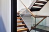Modern home with Staircase, Wood Tread, Wood Railing, and Glass Railing. Walnut and Steel stair connecting all floors Photo 4 of Lyon Residence